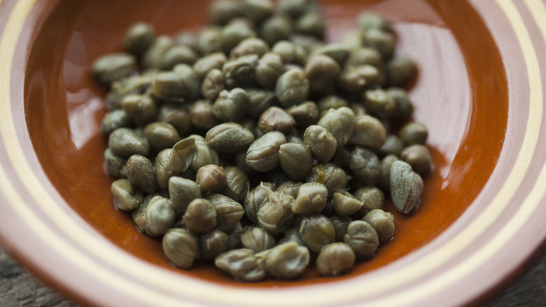 A close-up shot of capers on a plate