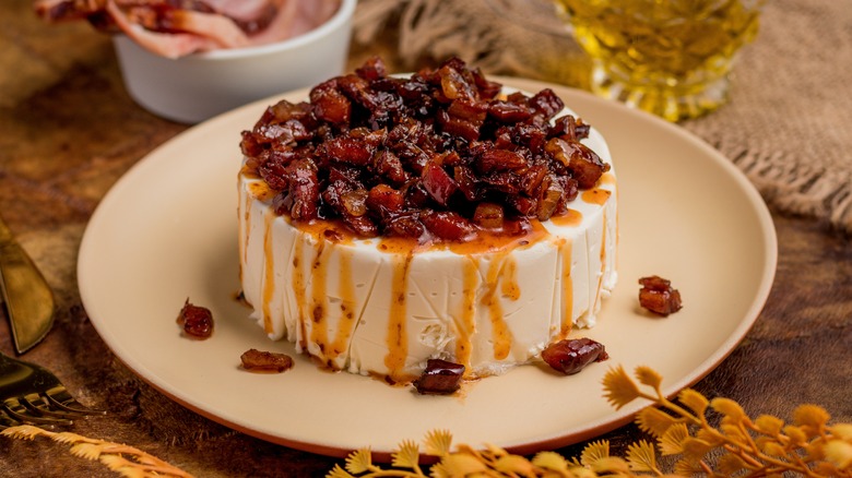 Cheesecake topped with bacon bits and drizzled with oil