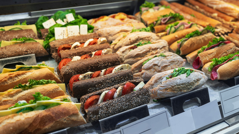 Different types of sandwiches are shown in a display case