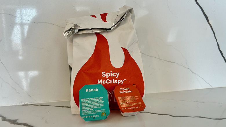 McDonald's McCrispy sandwich and two dipping sauce cups