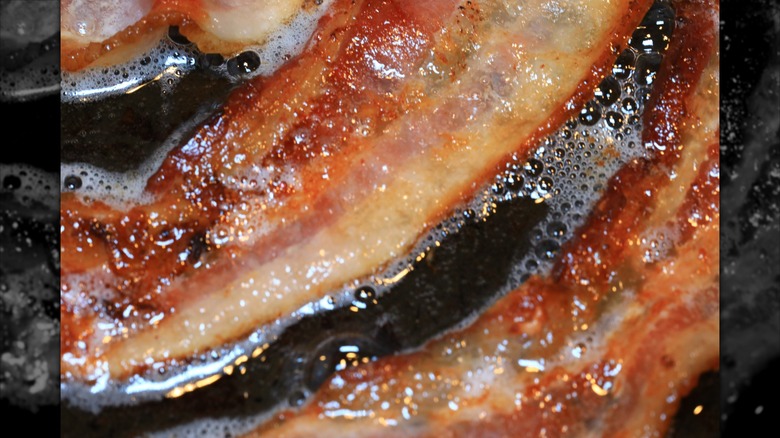 A close up of bacon while it's being cooked