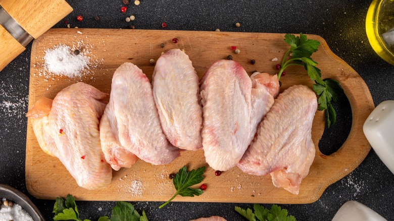 Raw chicken wings on cutting board