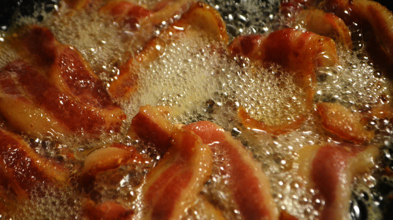 Close-up of bacon frying in grease