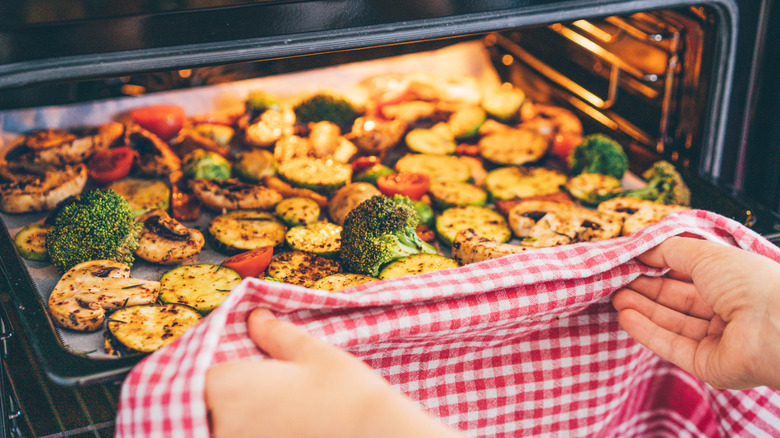 A tray of roasted veggies going into the oven