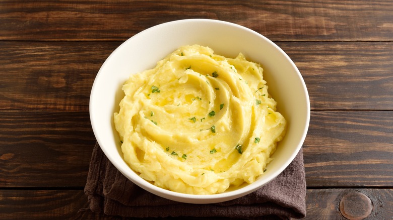 a bowl of mashed potatoes garnished with chives