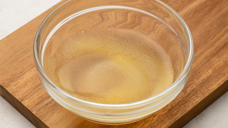 Blooming powdered gelatin in small glass bowl