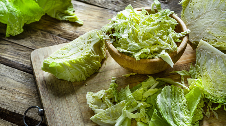 Shredded cabbage in a bowl and on a cutting board