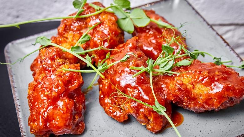 sauced up nuggets on a plate with garnish