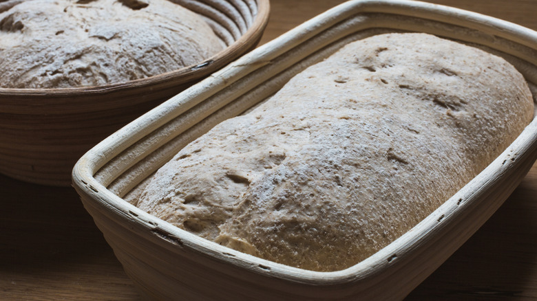 bread dough proofing in seemingly wooden baskets