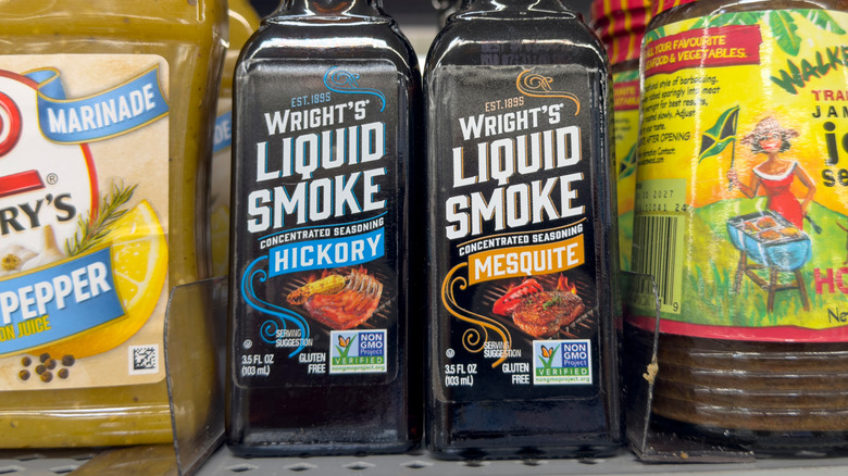 Two bottles of Wright's Liquid Smoke; one bottle is derived from hickory and the other is made from mesquite.