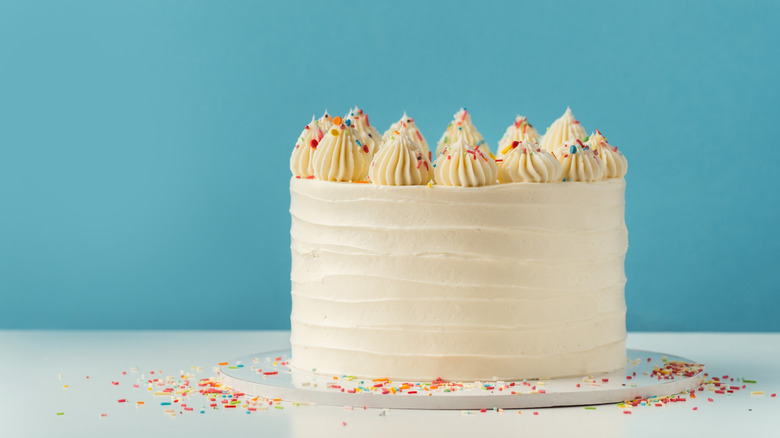 frosted round white cake with sprinkles