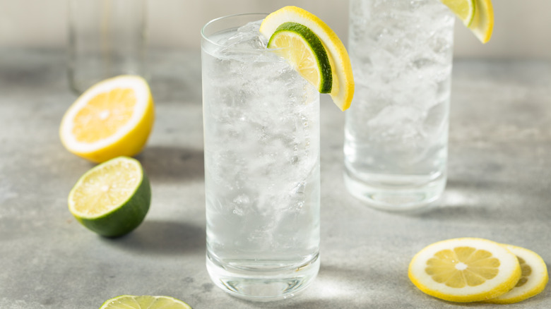 Close up of a glass of lemon lime soda with slices of lemon and lime