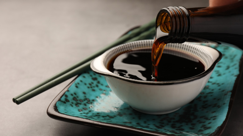 pouring soy sauce into bowl