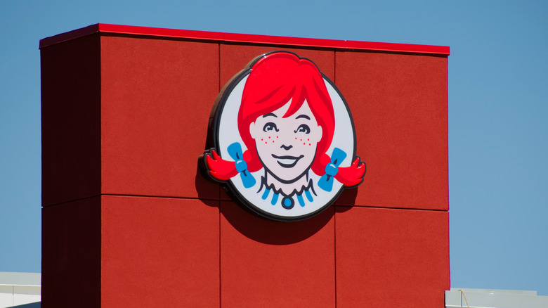 The exterior of a Wendy's with the logo sign.