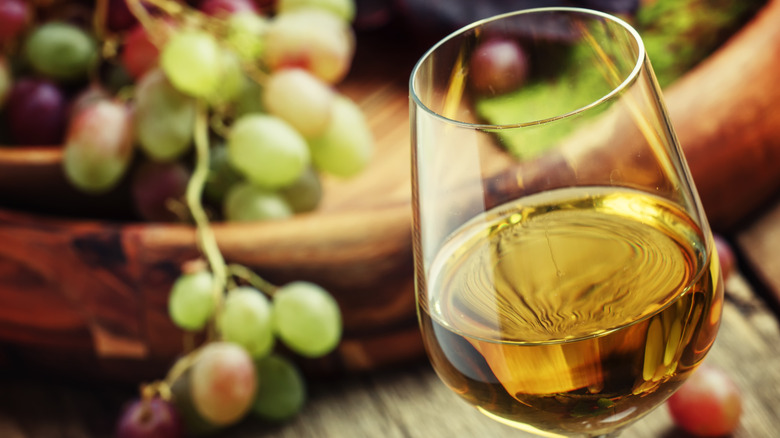 ice wine in glass background grapes