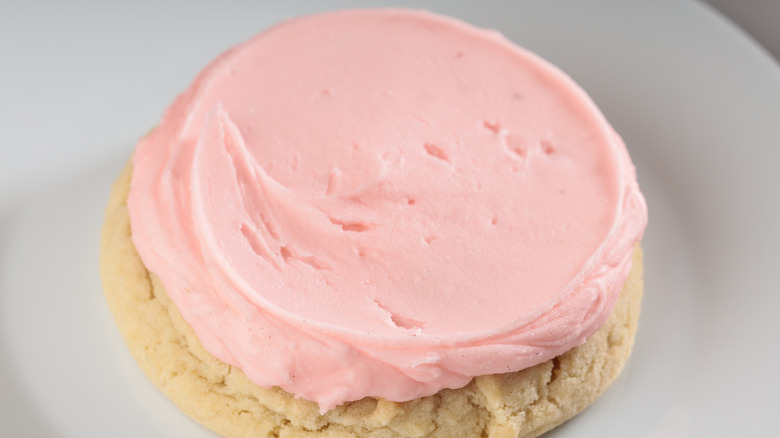 A cookie made from cake mix and topped with pink frosting