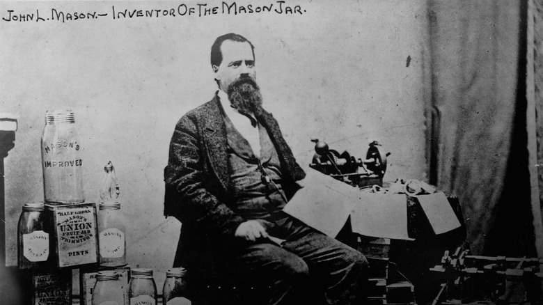 old photo of john landis mason, the inventor of the mason jar, posing beside mason jars