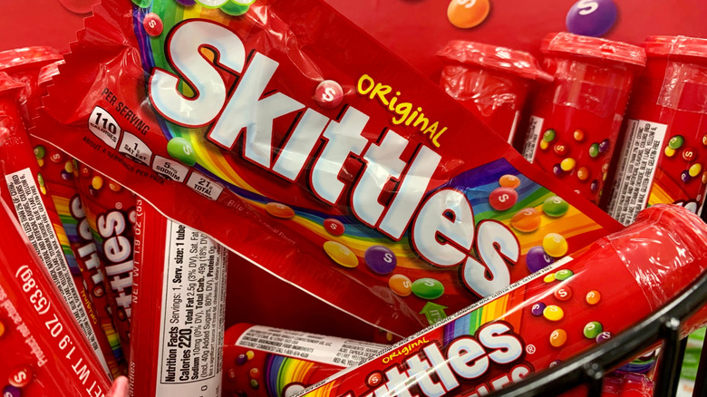 a bag of Skittles amidst tubes of Skittles