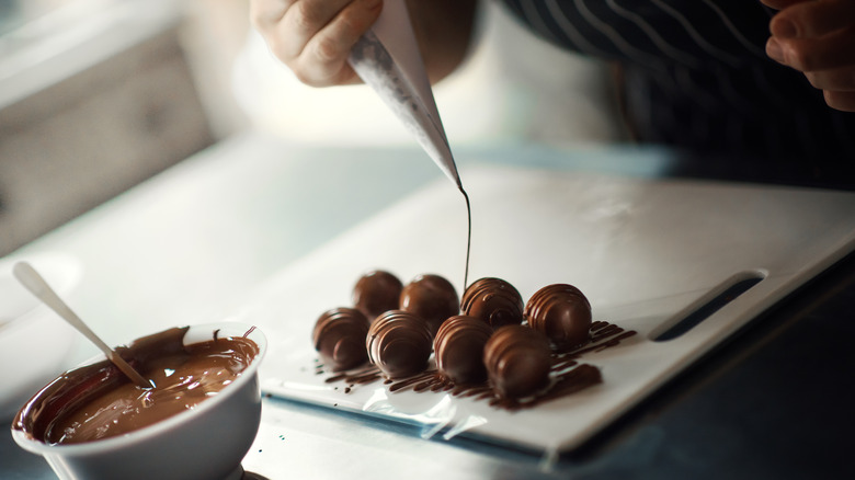 drizzling chocolate onto chocolate truffles