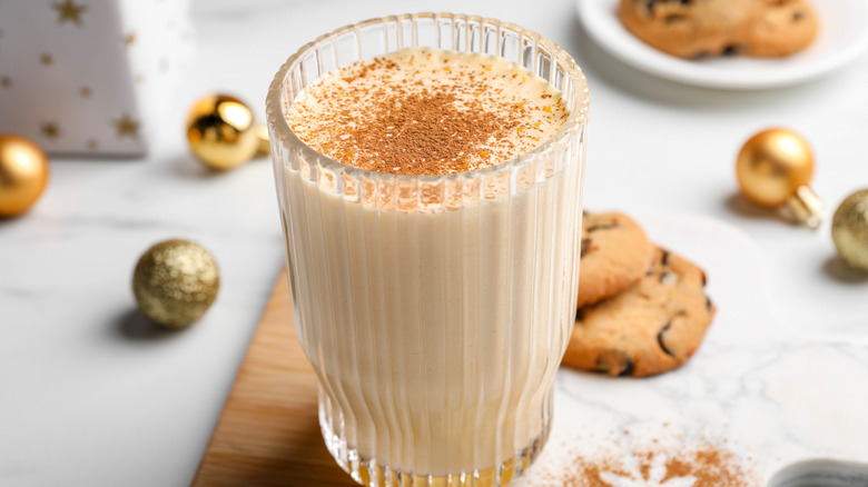 A glass of eggnog topped with cinnamon