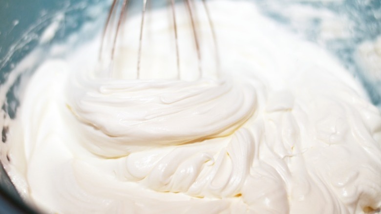 Heavy cream is whipped in a mixing bowl.