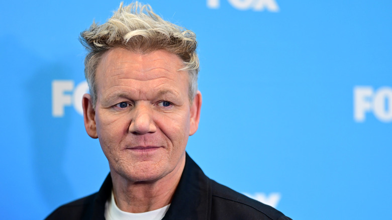 Close up of Gordon Ramsay in front of a blue backdrop