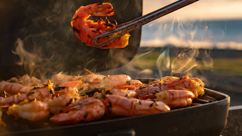 shrimp grilled on outside grill at sunset