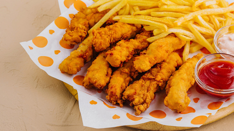 An image of chicken tenders and French fries.