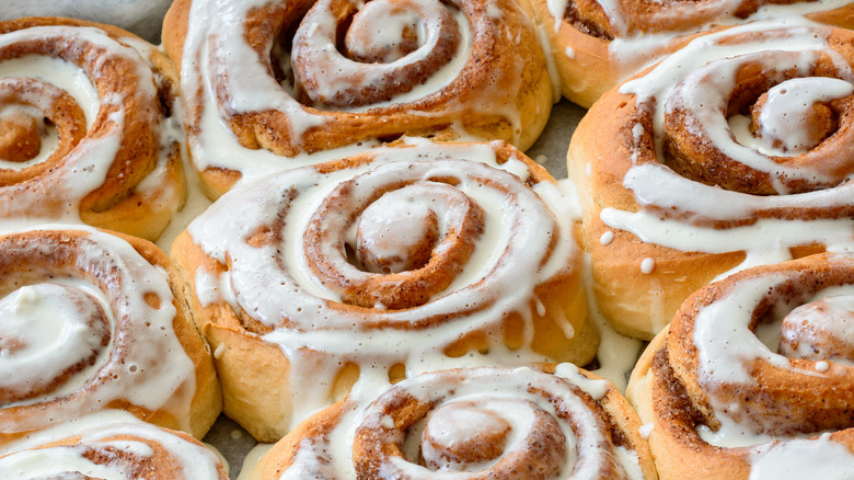 Close-up of several frosted cinnamon rolls