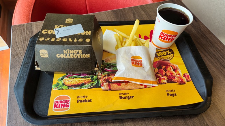 a burger king meal with burger, fries, and drink on a tray