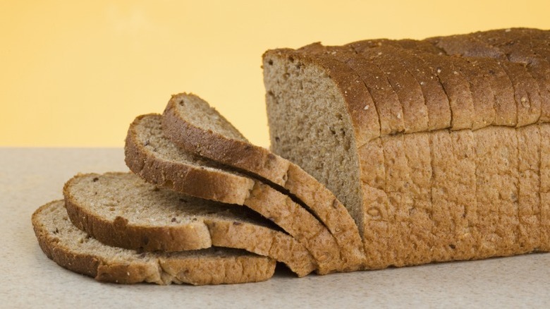 A sliced loaf of whole wheat bread