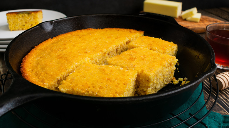 Cooked cut cornbread in a cast iron pan