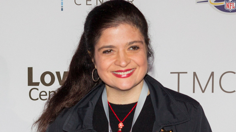 Alex Guarnaschelli smiling while looking away from camera