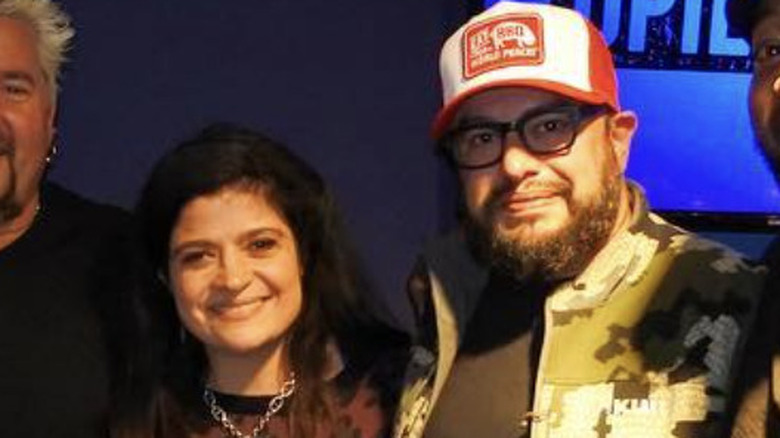 Alex Guarnaschelli embracing Carl Ruiz at a radio studio