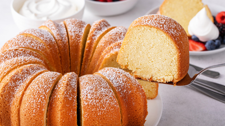 Bundt cake surrounded by fruit and whipped cream