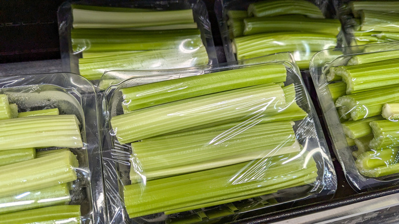 Packets of pre-cut celery on a grocery store produce shelf