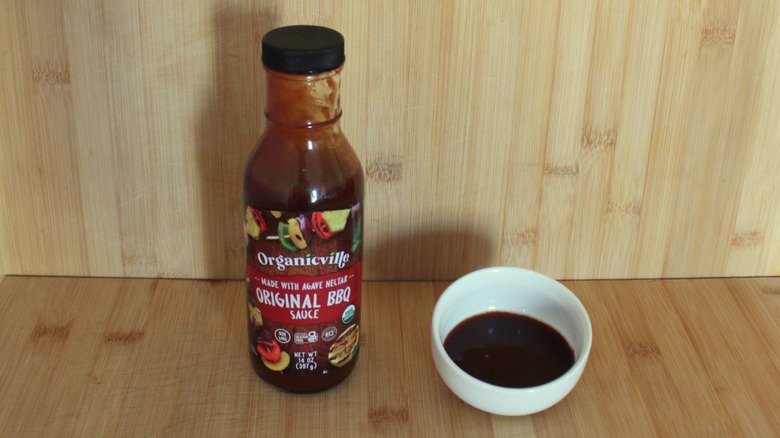 Container and bowl of Organicville Original BBQ Sauce