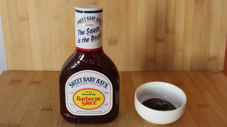 Container and bowl of Sweet Baby Ray's original barbecue sauce