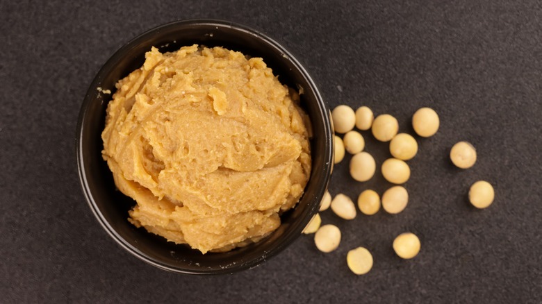 A bowl of tan miso paste with soy beans