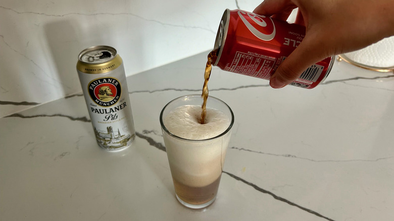 pouring coke into beer glass