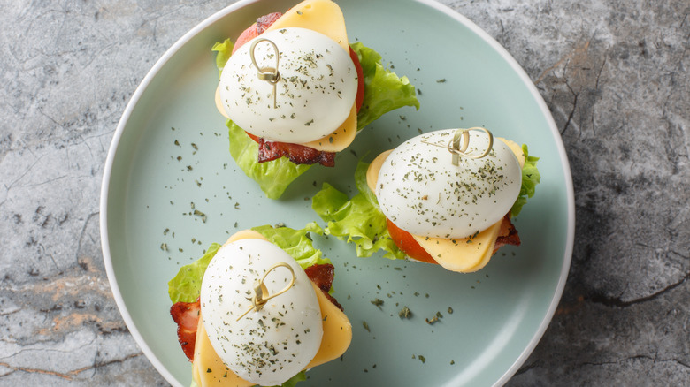 three deviled egg sliders on a blue plate