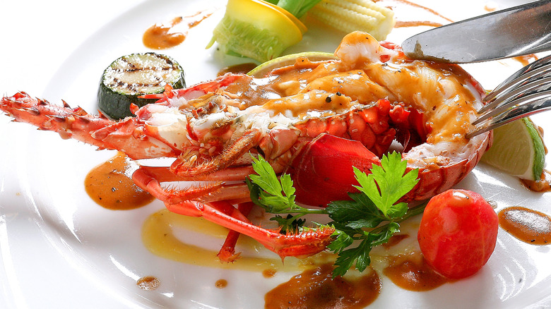 Baked lobster with sauce and assorted vegetables