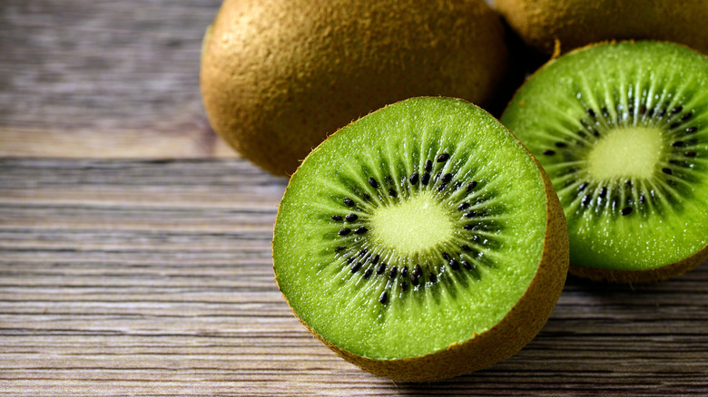 Whole and cut kiwi fruit