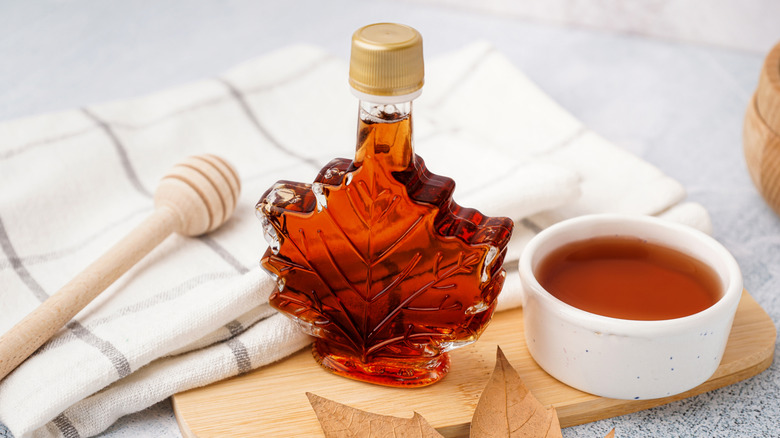 A bottle of maple syrup shaped like a maple leaf