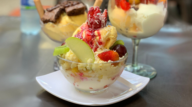 Colombian fruit salad served in a bowl with cream, cheese, and ice cream.