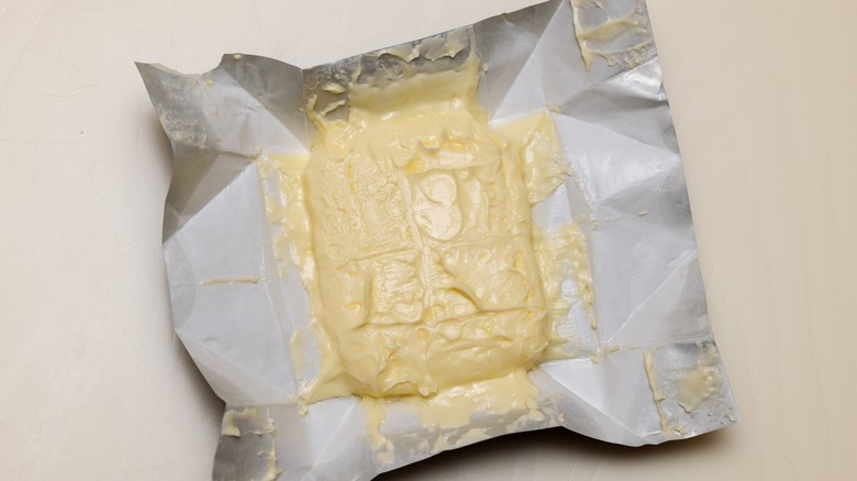 Unwrapped package of very soft butter