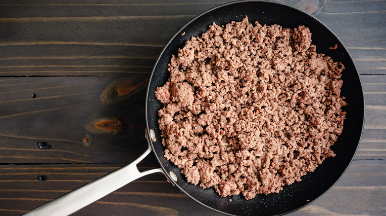 a skillet containing ground beef