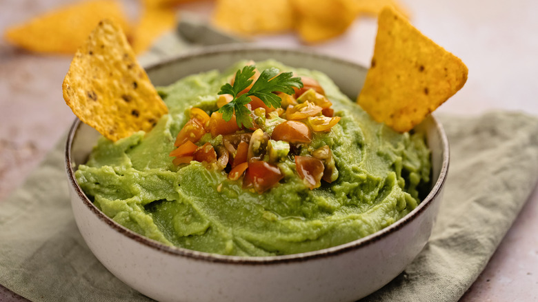 Bowl of guacamole with chips to dip