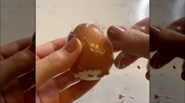 hands holding taped egg