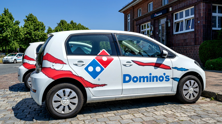 Domino's delivery car parked outside the restaurant